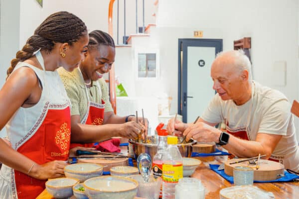 International travellers preparing Vietnamese dishes in a Hanoi full-day cooking class.
